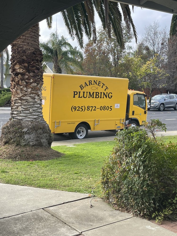 A Barnett plumbing truck parked on a street