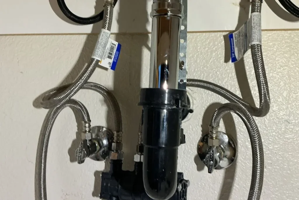 Braided water supply lines and drain under a bathroom vanity sink