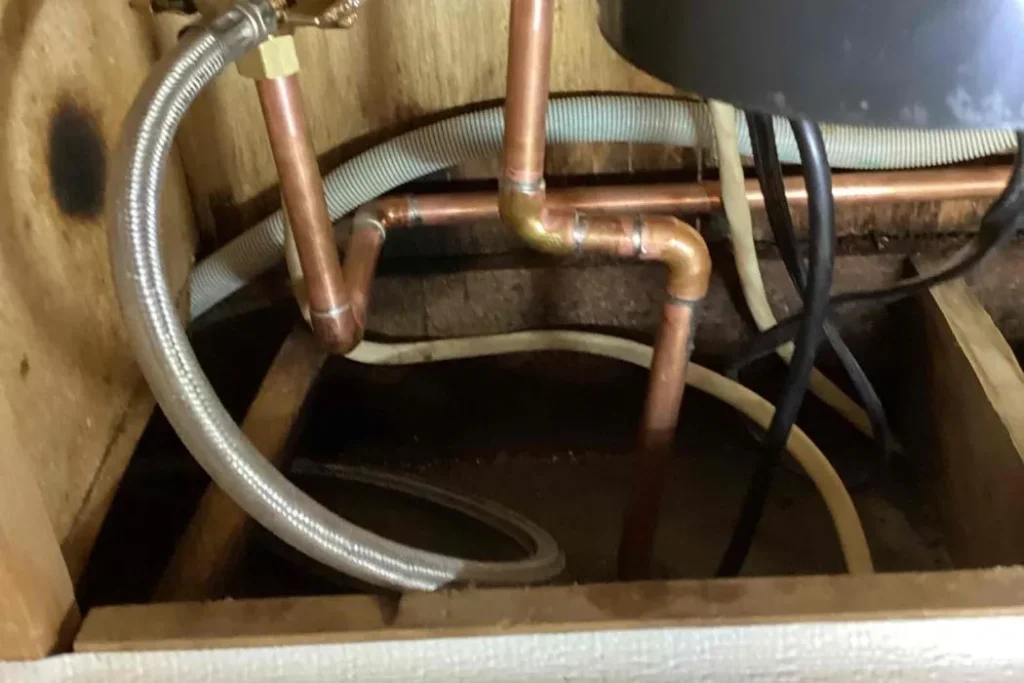 Copper water supply lines and connections under a kitchen sink